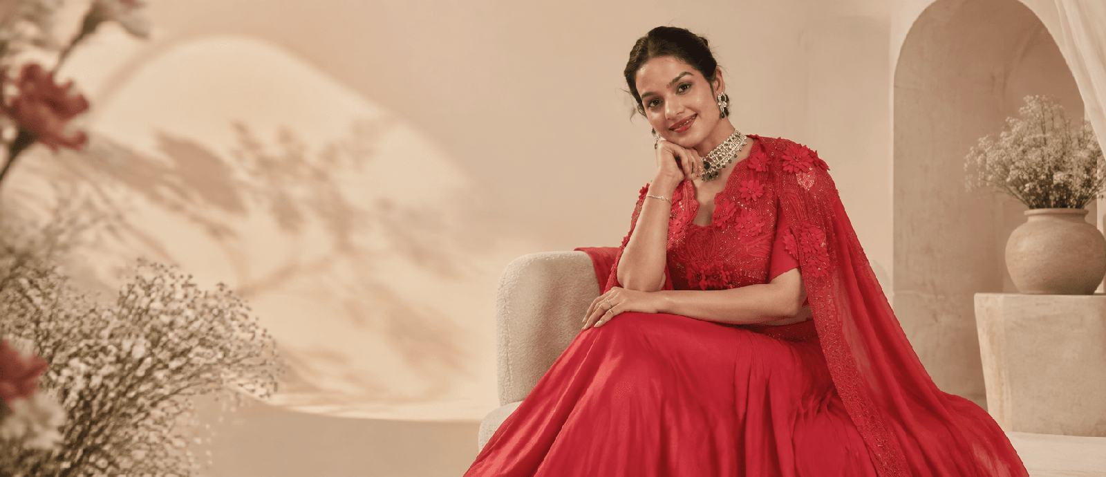 Garima, Founder and Creative Director of Miraya by Garima, in red couture ensemble